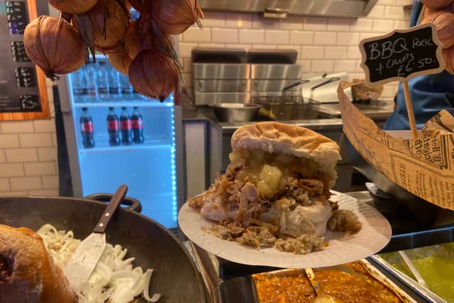 There is plenty of food and refreshment on offer, like this pork, stuffing and apple sauce cob. (Photo: Shannon Samecki)