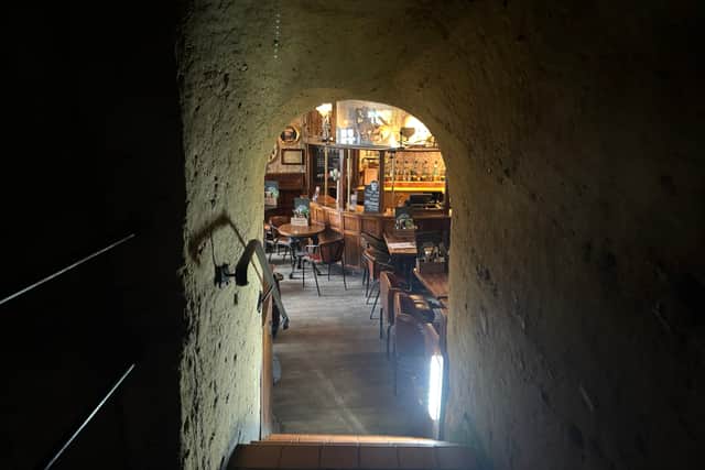 The pub's interior is carved from the sandstone cliffs 